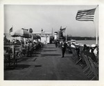 People Seated in Chairs Lined Up on Either Side of a Ship's Deck