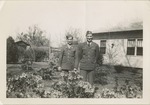 Two Uniformed Airmen Posing in a Flower Garden