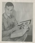 United States Air Force Airman Holding a Book and Smoking Pipe