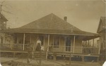 Woman and Child on the Front Porch of a House