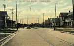 View of Buildings, a Trolly and Horsedrawn Carriages on South Bay Street, Hattiesburg, Mississippi