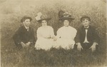Two Couples Posing in a Field
