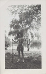Woman Holding a Cane Fishing Pole and a Fish