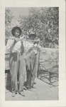Two Men Holding Fish From a Pole