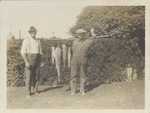 Two Men with Four Fish On a Pole
