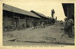 Side View of Men Walking past the Mess Halls at Camp Shelby, Hattiesburg, Mississippi