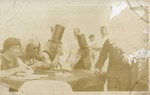 Men In Costume Around a Table