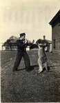 A Sailor in Dark Uniform Play Fighting a Kangaroo