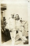 Two Sailors in Dirty White Uniforms on the Deck of a Ship
