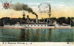 United States Battleship Kentucky on the Water with the Coast and Buildings Behind It