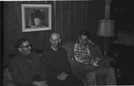 Three men sitting on sofa by Howard Langfitt