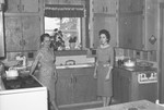 Woman and girl in kitchen by Howard Langfitt