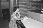 Woman talking on telephone by Howard Langfitt