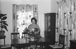 Woman in dining room by Howard Langfitt