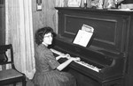 Girl playing the piano by Howard Langfitt