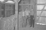 Three men inside barn by Howard Langfitt