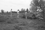 Three men at cleared land by Howard Langfitt
