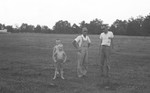 Two men and two boys in pasture by Howard Langfitt
