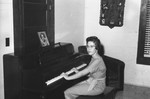 Girl playing piano by Howard Langfitt