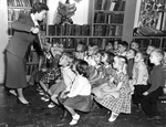 Librarian reads to school children