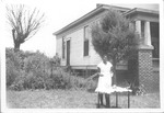 Woman With Table in Front of House