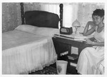 Woman Reading Next to Bed