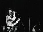 Man Singing into a Microphone on Stage, undated.