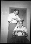 Fred A. Blocker Cuts Student's Hair by Fred A. Blocker