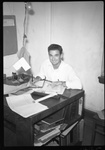 Student Behind Desk Working by Fred A. Blocker