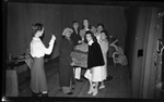 Group Holding Up Wooden Chest by Fred A. Blocker