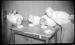 Students Eating Pies with Hands Behind Back by Fred A. Blocker