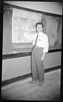 Teacher Pointing at Map by Fred A. Blocker