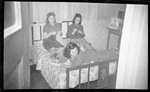 Students Lounging in Dorm Room by Fred A. Blocker