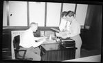 Students Reviewing Paperwork in an Office by Fred A. Blocker
