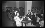 Students Dressed in Formal Clothing Sitting at Tables by Fred A. Blocker