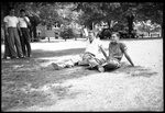 Students Sitting in Grass on Drill Field by Fred A. Blocker