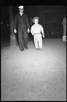 Sailor Walking with Short Person by Fred A. Blocker