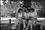 Students Looking at Photo Album by Fred A. Blocker