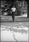 Student Walking Across the Street from Lee Hall by Fred A. Blocker