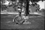 Couple Sitting in Grass by Fred A. Blocker