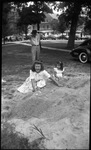 Kids Playing in Pile of Sand by Fred A. Blocker