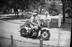 Police on Motorcycle on Campus by Fred A. Blocker