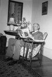 Man in Chair Reading Magazine by Fred A. Blocker