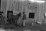 Animals and Handlers in front of Barn by Fred A. Blocker