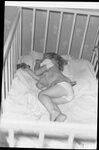 Girl Sleeping in Crib by Fred A. Blocker