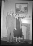 Couple Posing in front of Fireplace by Fred A. Blocker