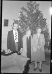 Group Standing in front of Christmas Tree by Fred A. Blocker