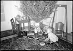Child Playing in front of Christmas Tree by Fred A. Blocker