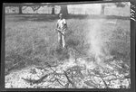 Boy Tossing Wood onto Fire by Fred A. Blocker
