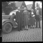 Couples Standing Outside Car by Fred A. Blocker